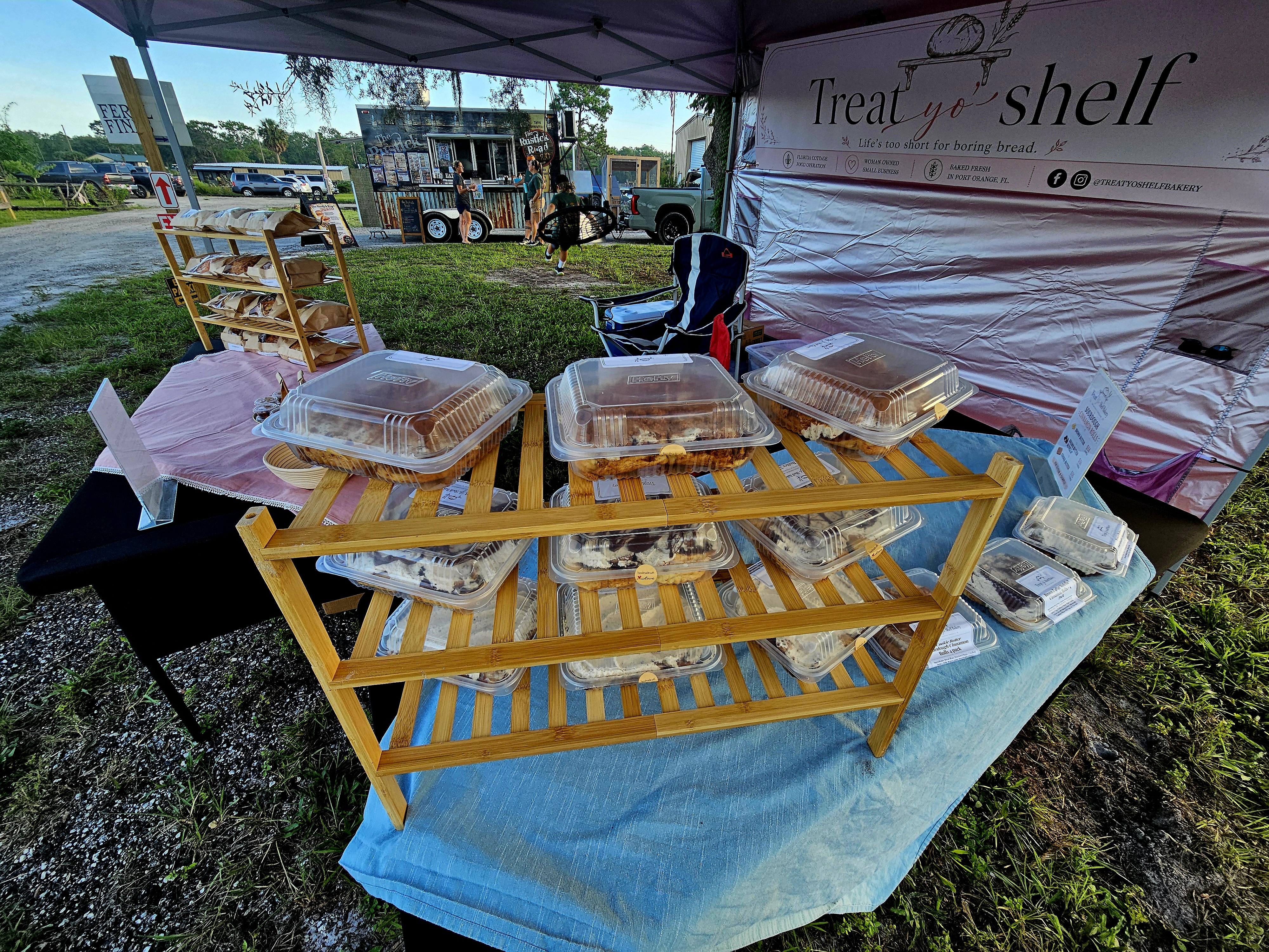 A full shelf of fresh-baked breads and treats on display at our local market setup.